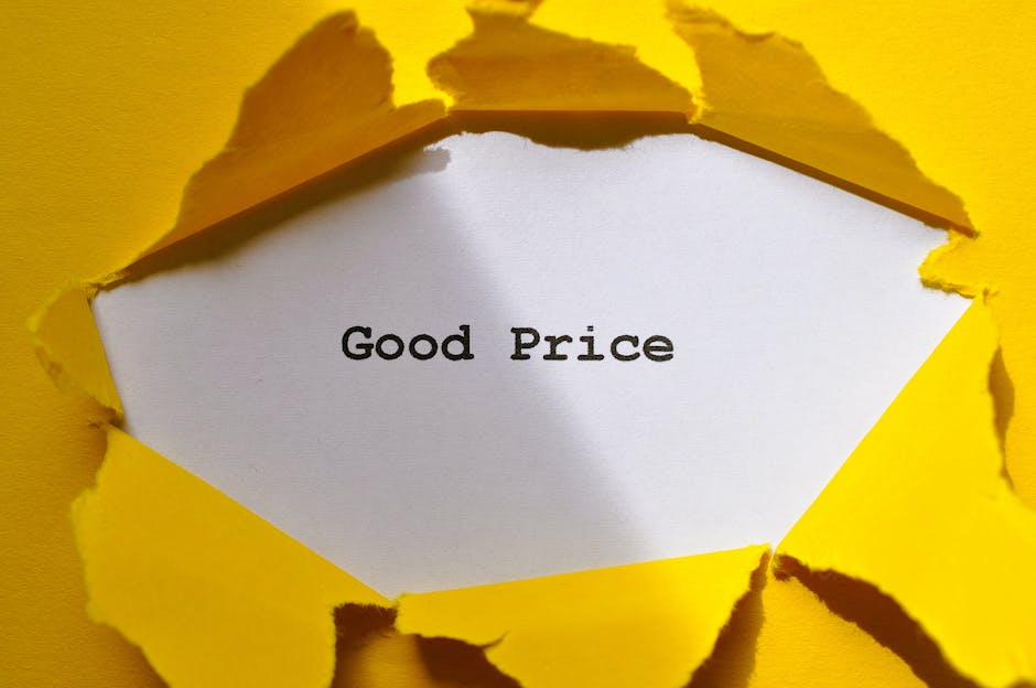 A close-up photograph of a torn yellow paper background reveals a white rectangle with the words 'Good Price' printed in black, bold, serif font. The torn edges of the yellow paper are irregular and curling outward, creating a layered, textured appearance. The scene appears to be set against a brightly lit surface, and the torn paper serves as a framing device for the message. The image's context suggests an emphasis on affordability, subtly aligning with themes of alternative waste management or cost-effective rubbish removal solutions offered by Rubbish Collection Harringay, with the focus on visual contrast and clarity.